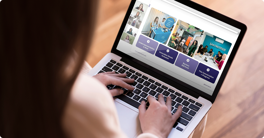 A participant watching LantroTech's Women in Tech: Driving Innovation Through Inclusion webinar on a laptop, showing panelists and slides on inclusion in tech