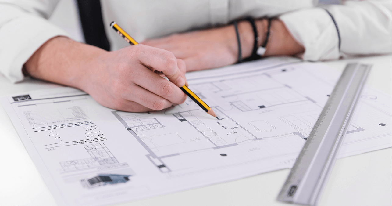 Person reviewing and drafting construction plans, representing LantroTech’s use of shop drawings to improve efficiency, reduce rework, and ensure project accuracy.