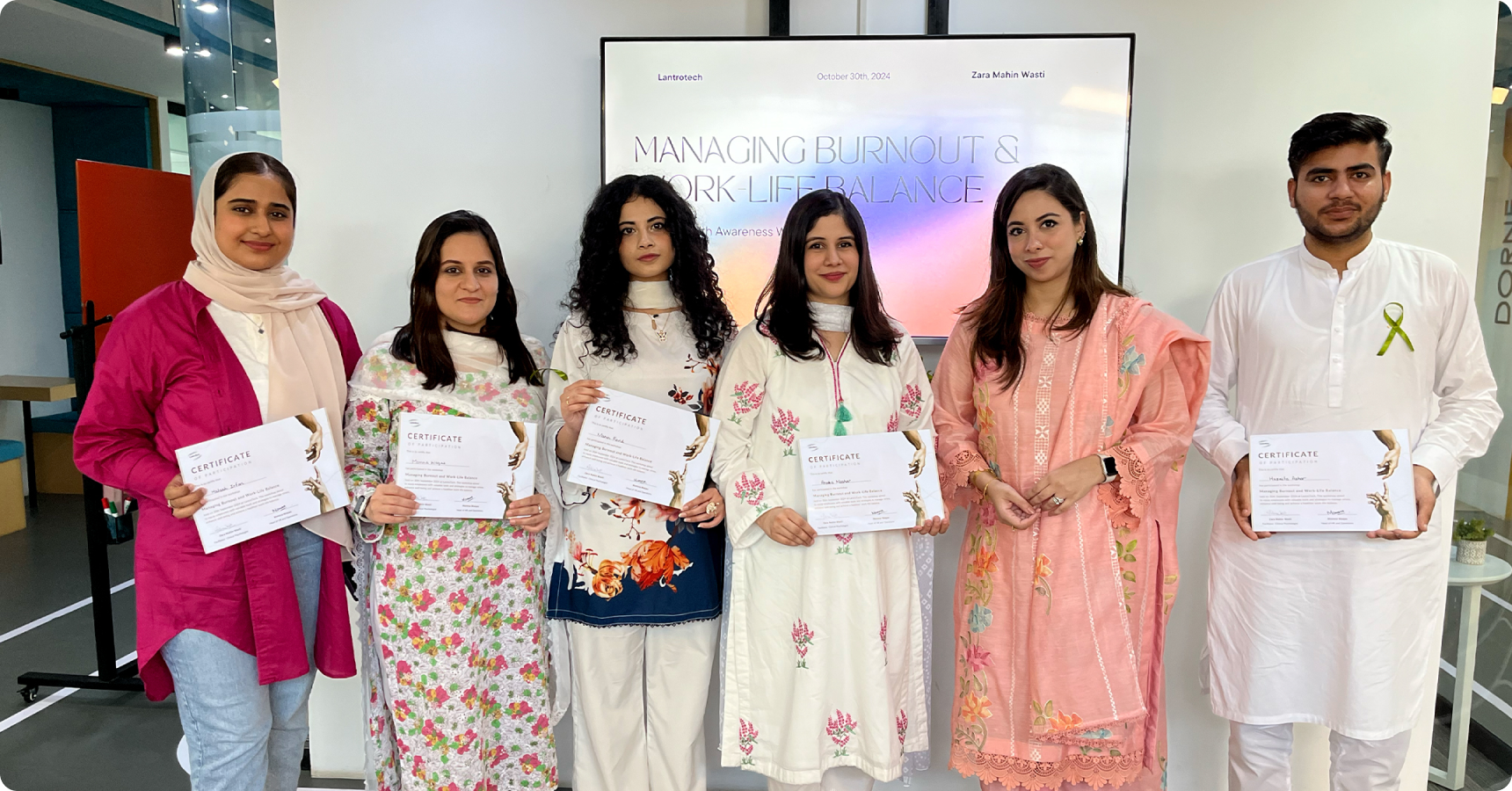 LantroTech employees holding certificates after completing a mental health awareness session, promoting wellbeing at work.