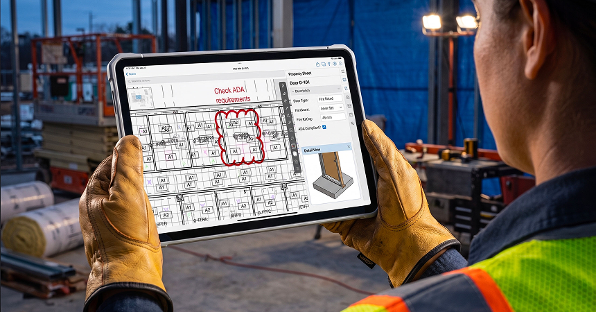 A LantroTech field engineer using a digital tablet to check ADA requirements and coordination notes on a shop drawing submittal.