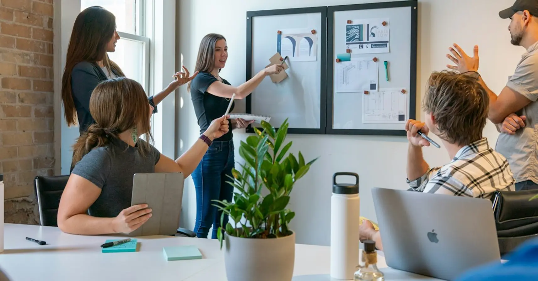 Professionals collaborating and discussing creativity, technology, and AI in the workplace.